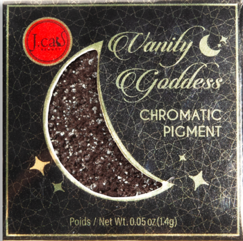 Chromatyczny pigment J.Cas Vanity Goddess w kształcie brokatowego księżyca na czarnym opakowaniu ze złotymi wzorami.