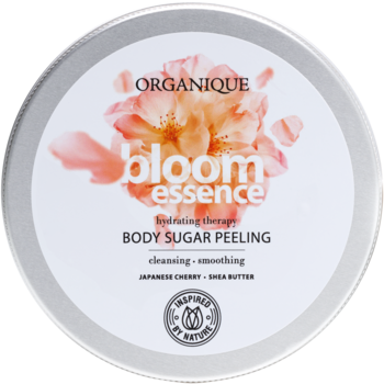 Organique Bloom Essence cukrowy peeling do ciała, srebrna puszka z kwiatami wiśni, widok z góry.