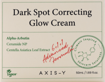 AXIS-Y Dark Spot Correcting Glow Cream 50ml, beżowe pudełko z zielonym tekstem i czerwoną adnotacją.