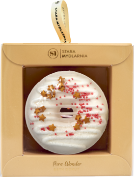 Musujący donut do kąpieli SWEET VANILLA, biały, z czerwonymi drobinkami i złotymi gwiazdkami, w beżowym pudełku.