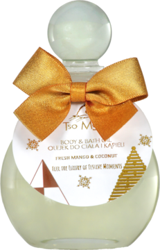 Rounded glass bottle of Tso M Fresh Mango & Coconut body & bath oil, with a gold satin bow and white brand tag.
