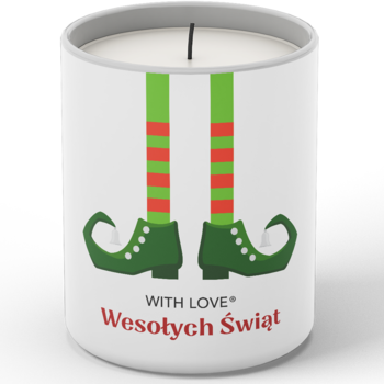 Biała sojowa świeczka świąteczna z grafiką zielono-czerwonych nóg elfa i napisem 'Wesołych Świąt', widok przodem.