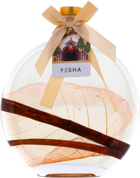 Yesha olejek do kąpieli pomarańcza z cynamonem 500ml w okrągłej butelce z widocznymi liśćmi i laskami cynamonu.