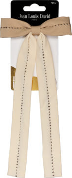 Spinka do włosów: beżowa kokarda z długimi tasiemkami, ozdobiona czarnymi szwami, na opakowaniu, widok z przodu.