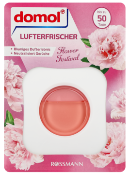Kwiatowy odświeżacz powietrza domol Flower Festival w różowym opakowaniu z okrągłym pojemnikiem płynu, na tle piwonii.