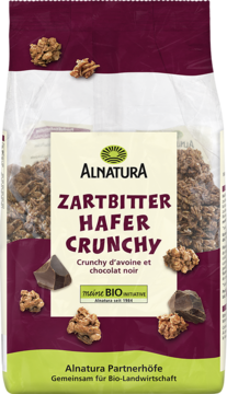 Alnatura Zartbitter Hafer Crunchy BIO: fioletowa torebka z zielonym paskiem, widok z przodu. Chrupiący owies z gorzką czekoladą.
