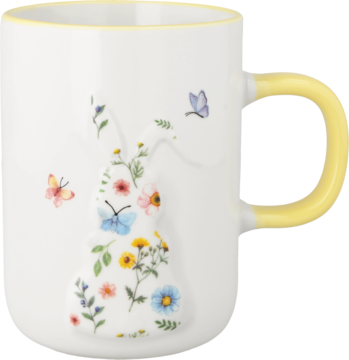 Biały ceramiczny kubek z żółtym uchwytem i obwódką. Front zdobi reliefowy zajączek z kwiatów i motyli.
