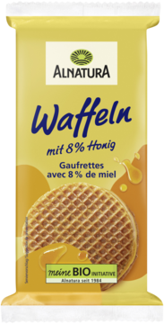 Front opakowania wafli Alnatura z 8% miodu, żółte tło z dużym waflem i rozlewającym się złotym miodem.