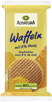 Front opakowania wafli Alnatura z 8% miodu, żółte tło z dużym waflem i rozlewającym się złotym miodem.