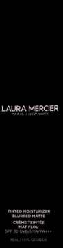 Laura Mercier Tinted Moisturizer Blurred Matte SPF 30. Widok z przodu czarnego opakowania z białym tekstem.