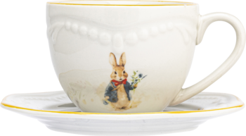 Kremowa filiżanka z uszkiem i spodek z porcelany z żółtymi brzegami, ozdobione Królikiem Piotrusiem.