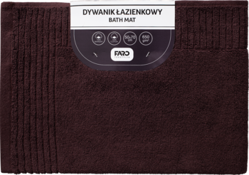 Czekoladowy dywanik łazienkowy, zapakowany, z widoczną prążkowaną fakturą, etykieta na wierzchu.