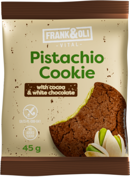 Frank&Oli Pistachio Cookie 45g. Beżowe opakowanie z ugryzionym ciastkiem kakaowym, zielonym nadzieniem, białą czekoladą.