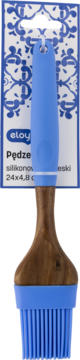 Niebieski pędzel silikonowy Eloy z drewnianą rączką, na opakowaniu detalicznym z niebieskimi zdobieniami. Z przodu.