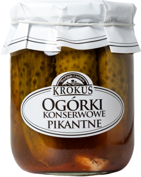 Krokus Ogórki Konserwowe Pikantne w szklanym słoiku, widok z przodu, z chrzanem, czosnkiem i koprem.