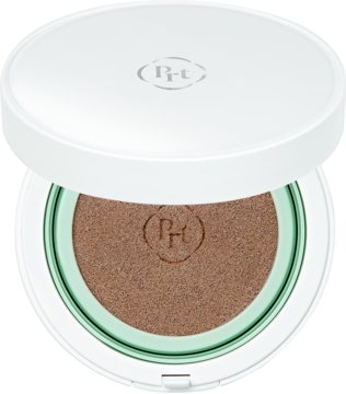 Otwarty biały kompaktowy krem BB z półmatowym wykończeniem, widok z góry na brązowy wkład i zielony detal.