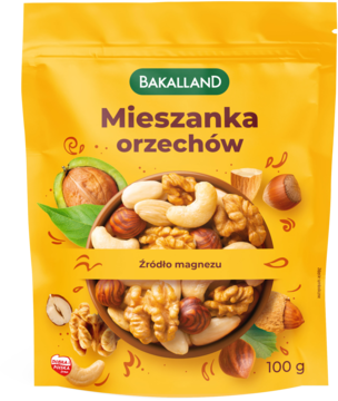 Żółta torebka Bakalland Mieszanka orzechów 100g, z grafiką, "źródło magnezu". Widok z przodu.