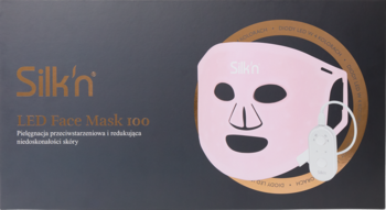 Silk'n Facial LED Mask 100, różowa maska LED na twarz widoczna na ciemnym opakowaniu produktu.