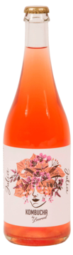 Butelka Kombucha by Laurent Julia, fermentowany napój, różowa ciecz, etykieta z kwiatową grafiką twarzy, widok z przodu.