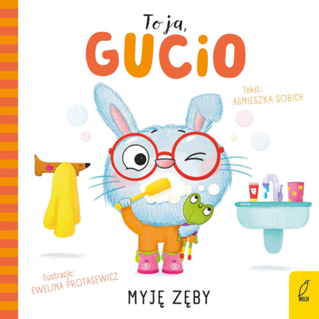 Kartonowa książeczka „To ja, Gucio! Myję zęby” z niebieskim zajączkiem w okularach, szczotkującym zęby, widok z przodu.