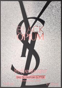 YSL Black Opium Eau de Parfum Glitter, front srebrnego opakowania z brokatem, czarne logo, różowe napisy.