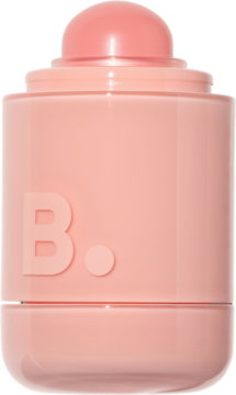 Brzoskwiniowy kremowy róż w sztyfcie. Błyszczące, cylindryczne opakowanie z logo B. i wysuniętą kopułką produktu.