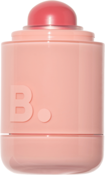 Róż w sztyfcie B. w matowym, brzoskwiniowym opakowaniu z różowym, kopułkowym aplikatorem, widok z przodu.