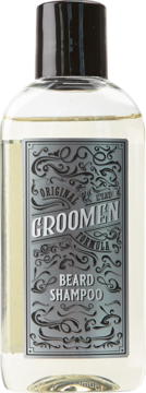 Groomen Beard Shampoo w przezroczystej butelce z jasnym płynem i czarną zakrętką, srebrna etykieta z ornamentami, widok z przodu.