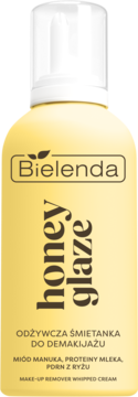 Żółta butelka Bielenda Honey Glaze: odżywcza śmietanka do demakijażu z miodem manuka i ryżem, widok z przodu.