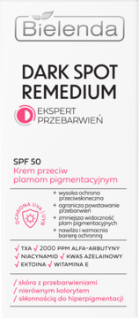 Bielenda DARK SPOT REMEDIUM, krem SPF 50 przeciw plamom pigmentacyjnym. Białe opakowanie z różowym logo, widok z przodu.