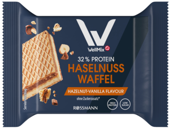 Ciemnoniebieski baton proteinowy VIBE+ Rossmann, smak orzech laskowy wanilia, 32% białka. Na opakowaniu wafel i orzechy.
