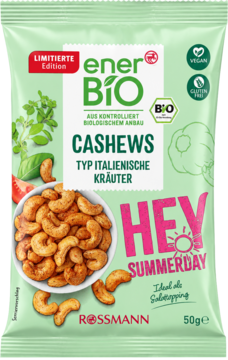 Zielona torebka Rossmann enerBIO Cashews, 50g, włoskie zioła, z miską prażonych orzechów i świeżymi ziołami.