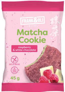 Różowe opakowanie Frank & Oli Matcha Cookie malina, biała czekolada bez cukru. Widać ciastko z zielonym wnętrzem.