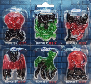 Sześć kolorowych Monster Jelly w blistrach: czerwona czaszka, zielony Frankenstein, diabelska głowa, dłoń, nietoperz, duch.