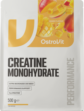 OstroVit Kreatyna Monohydrat 500g, biała torebka z pomarańczowym logo i grafiką mango, widok z przodu.