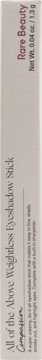 Jasne opakowanie Rare Beauty All of the Above Weightless Eyeshadow Stick Compassion, z tekstem pionowo, widok z boku.