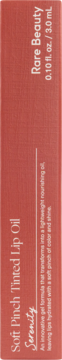 Front of coral Rare Beauty Soft Pinch Tinted Lip Oil box, Serenity shade, 0.10 fl. oz./3.0 mL volume.