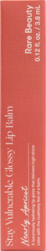 Rare Beauty Stay Vulnerable Glossy Lip Balm in Nearly Apricot box, upright, showing product name and shade.