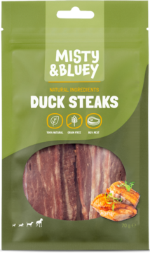 Zielone opakowanie Misty & Bluey Duck Steaks dla psa, z oknem ukazującym ciemne, suszone kawałki kaczki.