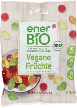 Przezroczysta torba enerBiO Vegane Früchte Rossmann. Zielona etykieta i rozsypane, kolorowe wegańskie żelki.