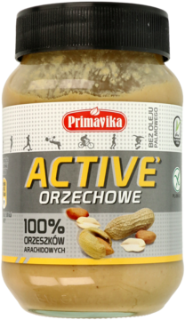 Primavika Active Orzechowe, masło arachidowe 100% w szklanym słoiku z żółtą etykietą, widok z przodu.