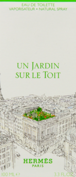 Białe pudełko perfum Hermès Un Jardin Sur Le Toit, z rysunkiem Paryża i zielonym ogrodem na dachu.