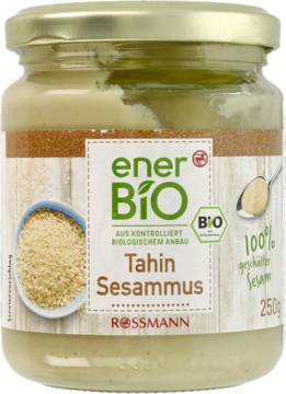 Szklany słoik enerBiO Tahini z sezamu, widok z przodu. Jasnobeżowa pasta, zielona etykieta, złote wieczko, 250g.