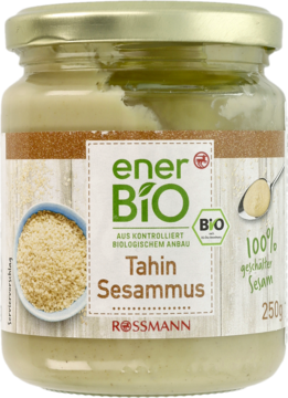 Szklany słoik enerBiO Tahini z sezamu, widok z przodu. Jasnobeżowa pasta, zielona etykieta, złote wieczko, 250g.