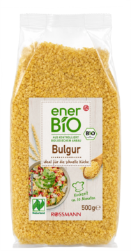 Duża torebka ekologicznej kaszy bulgur enerBiO 500g, przezroczysta, z etykietą widoczną z przodu, z logo Rossmann.