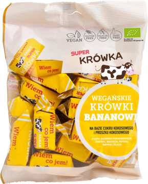 Biała torba wegańskich krówek bananowych Super Krówka, z żółtymi cukierkami 'Wiem co jem!', widok z przodu.