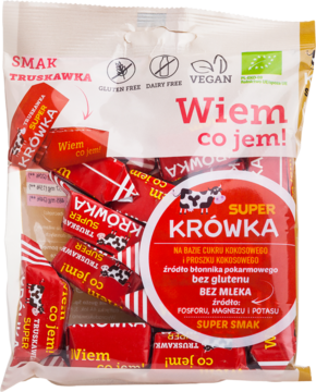 Opakowanie ekologicznych truskawkowych krówek Super Krówka. Przezroczysta torba z czerwonymi cukierkami, widok z przodu.