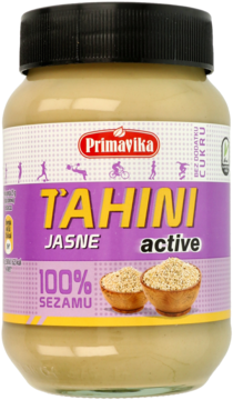 Słoik Primavika Tahini Jasne Active 100% sezamu, z fioletowo-żółtą etykietą i czarną zakrętką, widok z przodu.