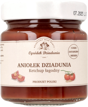 Ketchup łagodny Aniołek Dziadunia w przezroczystym słoiku z białą nakrętką i etykietą, z przodu.