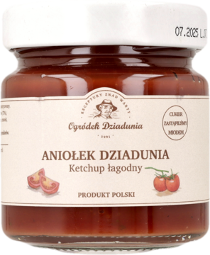 Ketchup łagodny Aniołek Dziadunia w przezroczystym słoiku z białą nakrętką i etykietą, z przodu.